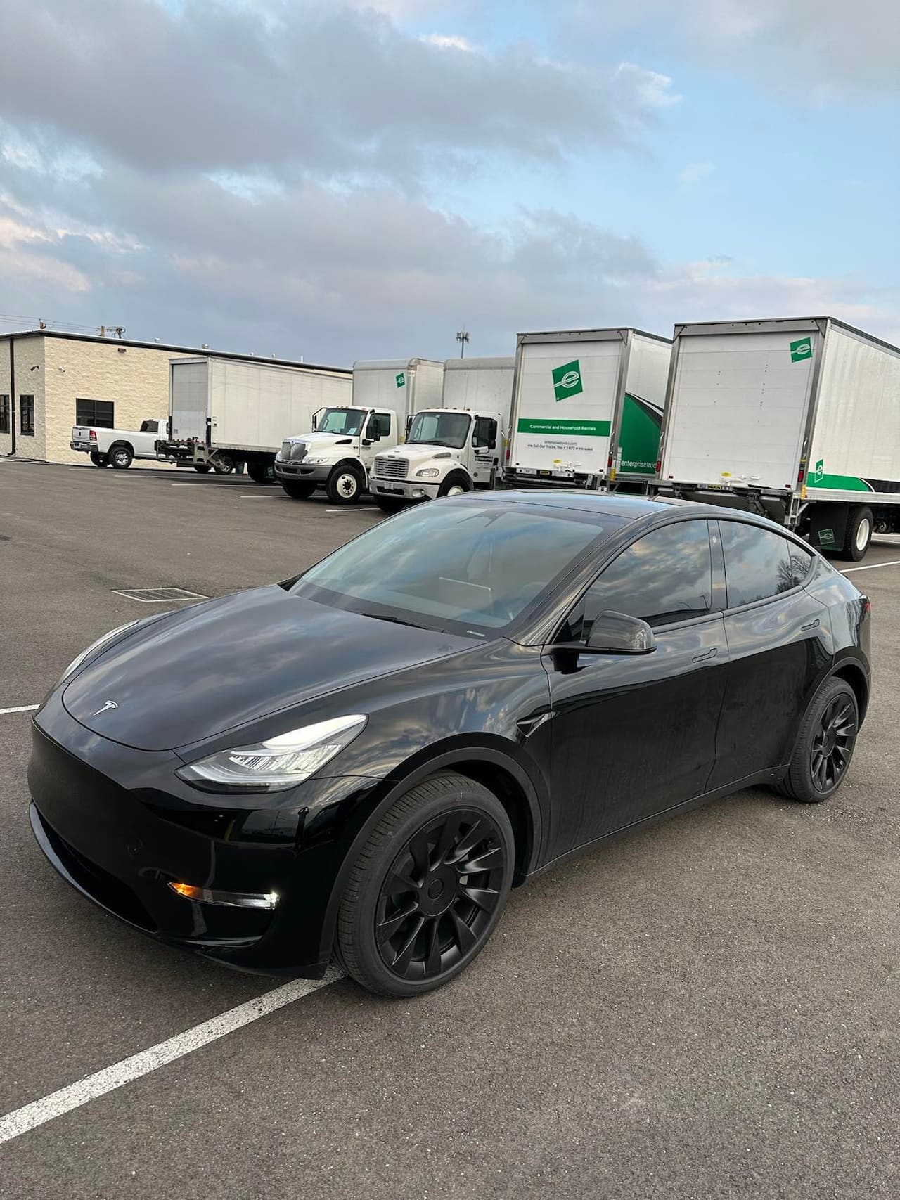 Black Tesla Model Y with tinted windows and gloss black wheels
