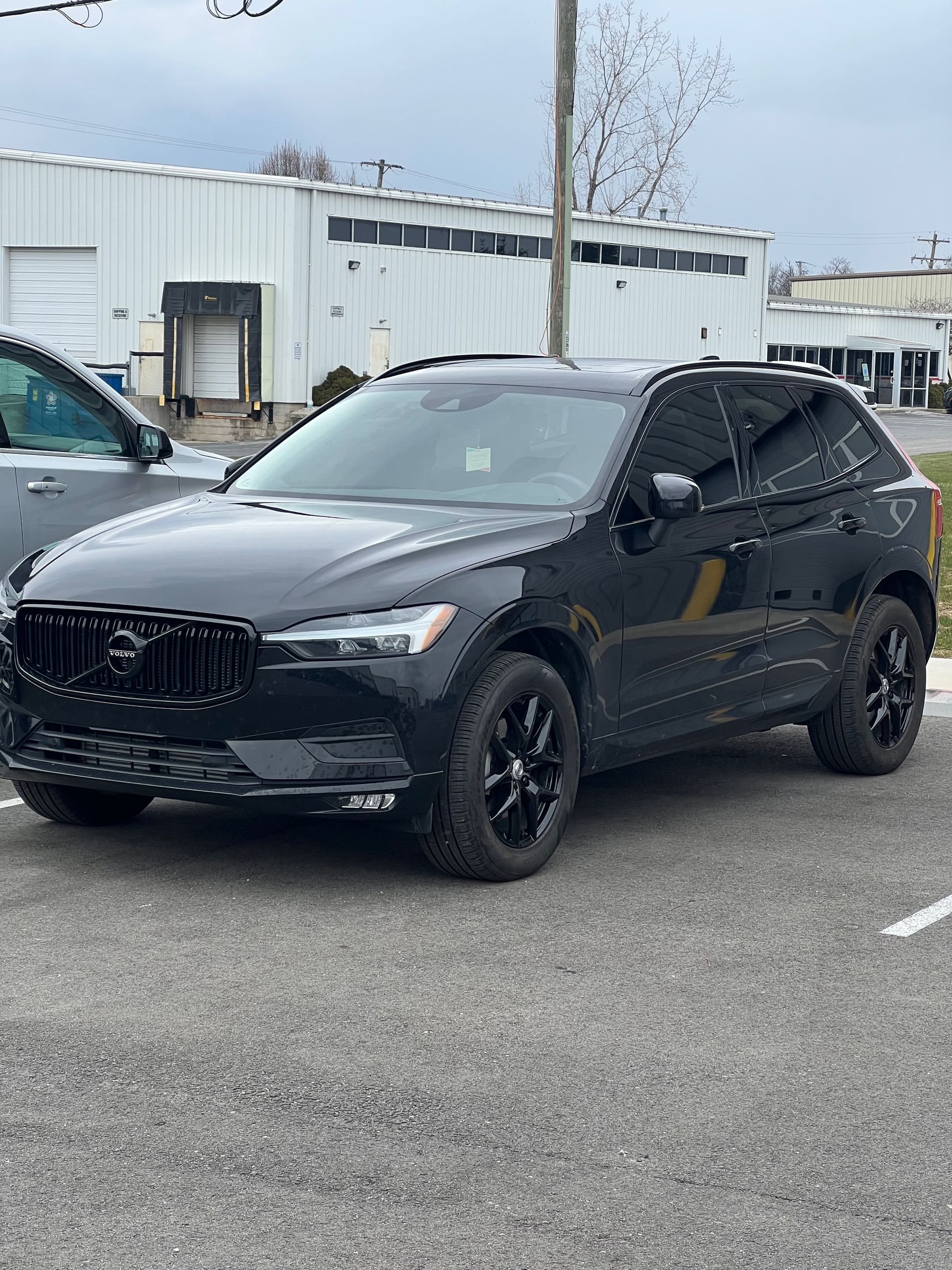 Black Volvo XC60 with dark tinted glass and blacked-out wheels